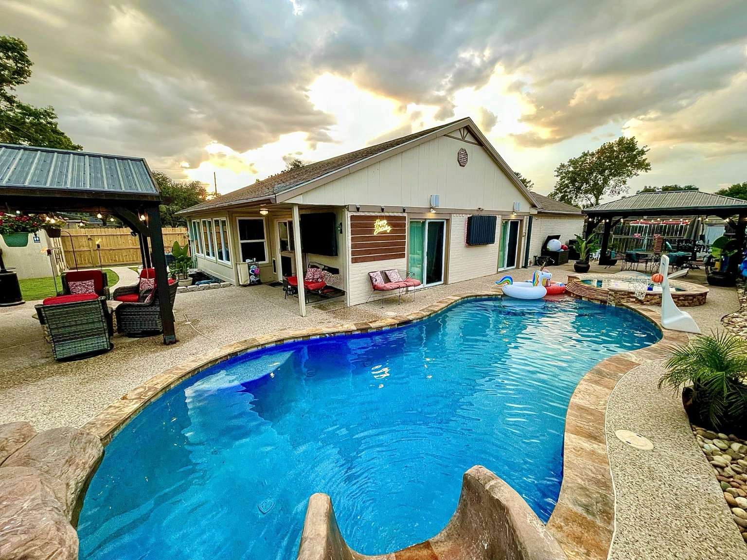Cypress River Oasis pool and pavilions at sunset