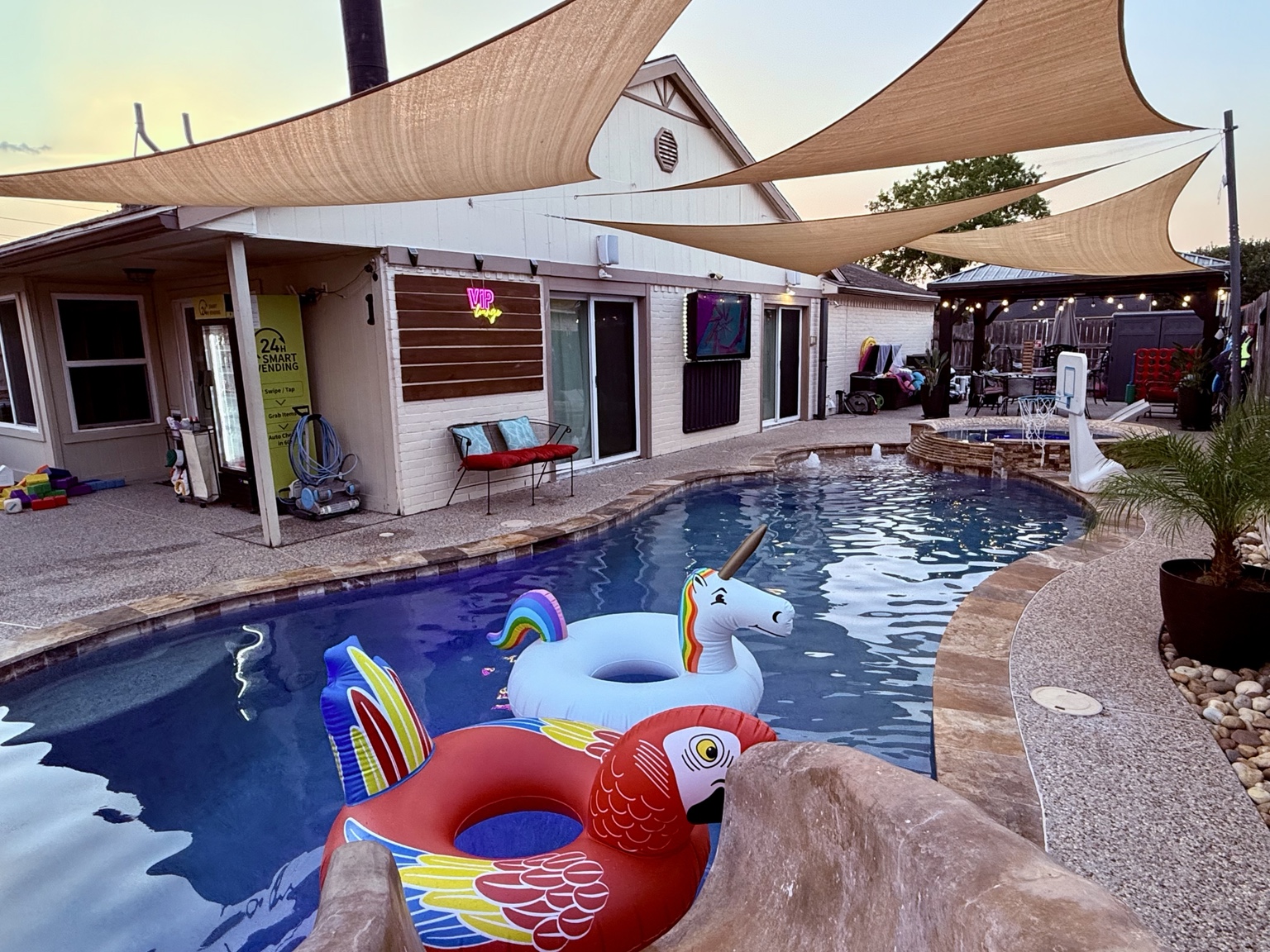 Pool with colorful floats and shaded seating