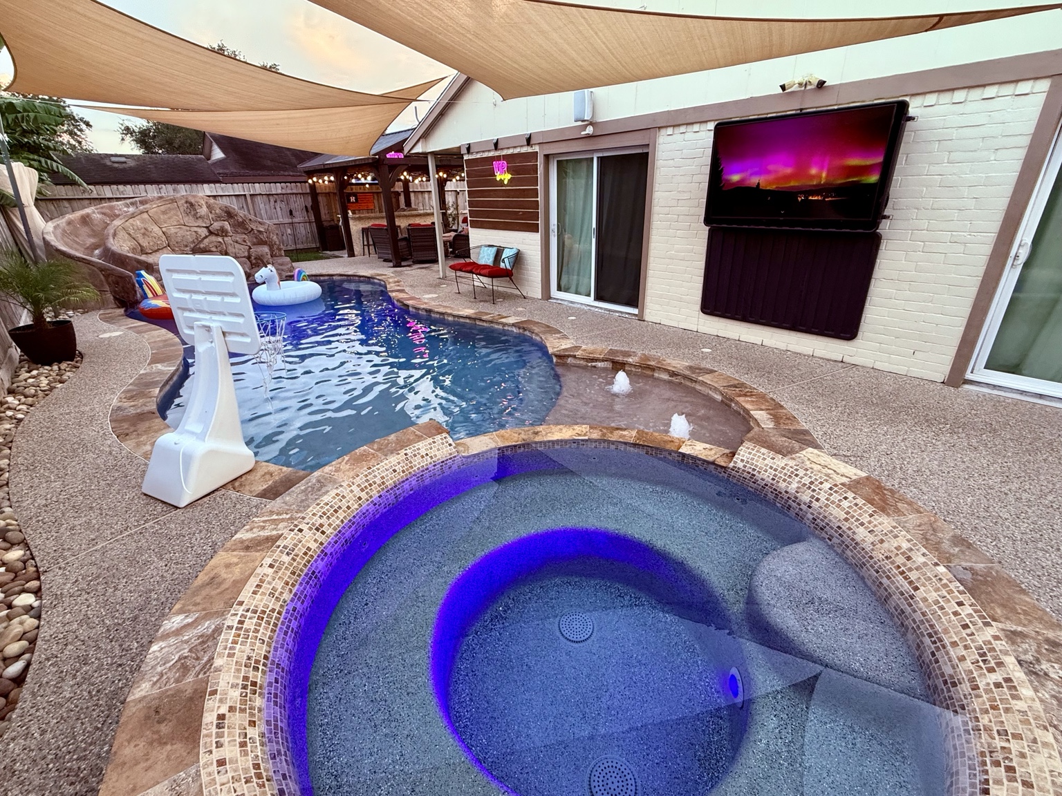 Poolside television and hot tub