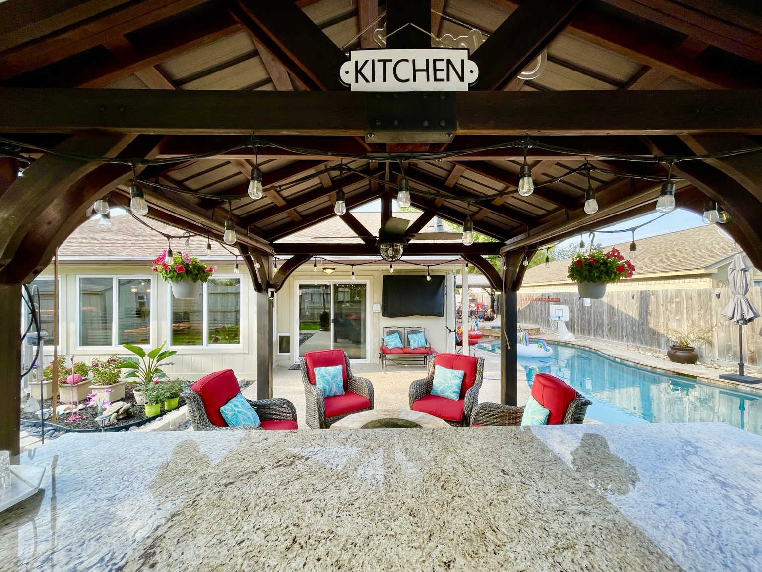 Outdoor kitchen view across the pool