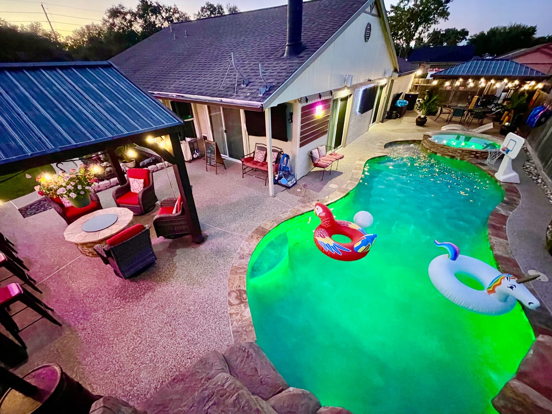 Aerial view of the pool, hot tub and covered seating