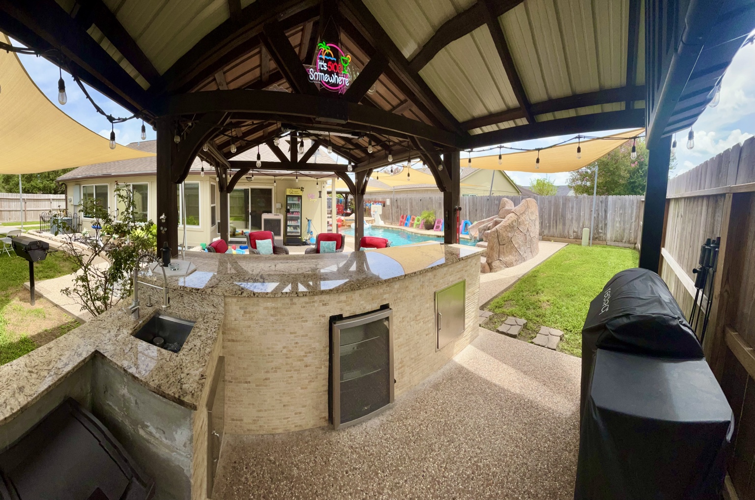 Granite bar, sink, refrigerator, and grill