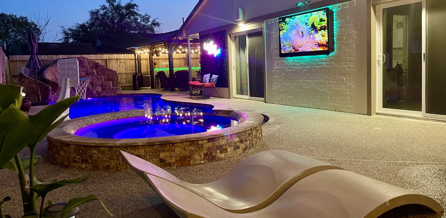 Raised hot tub, pool lighting and outdoor television at night
