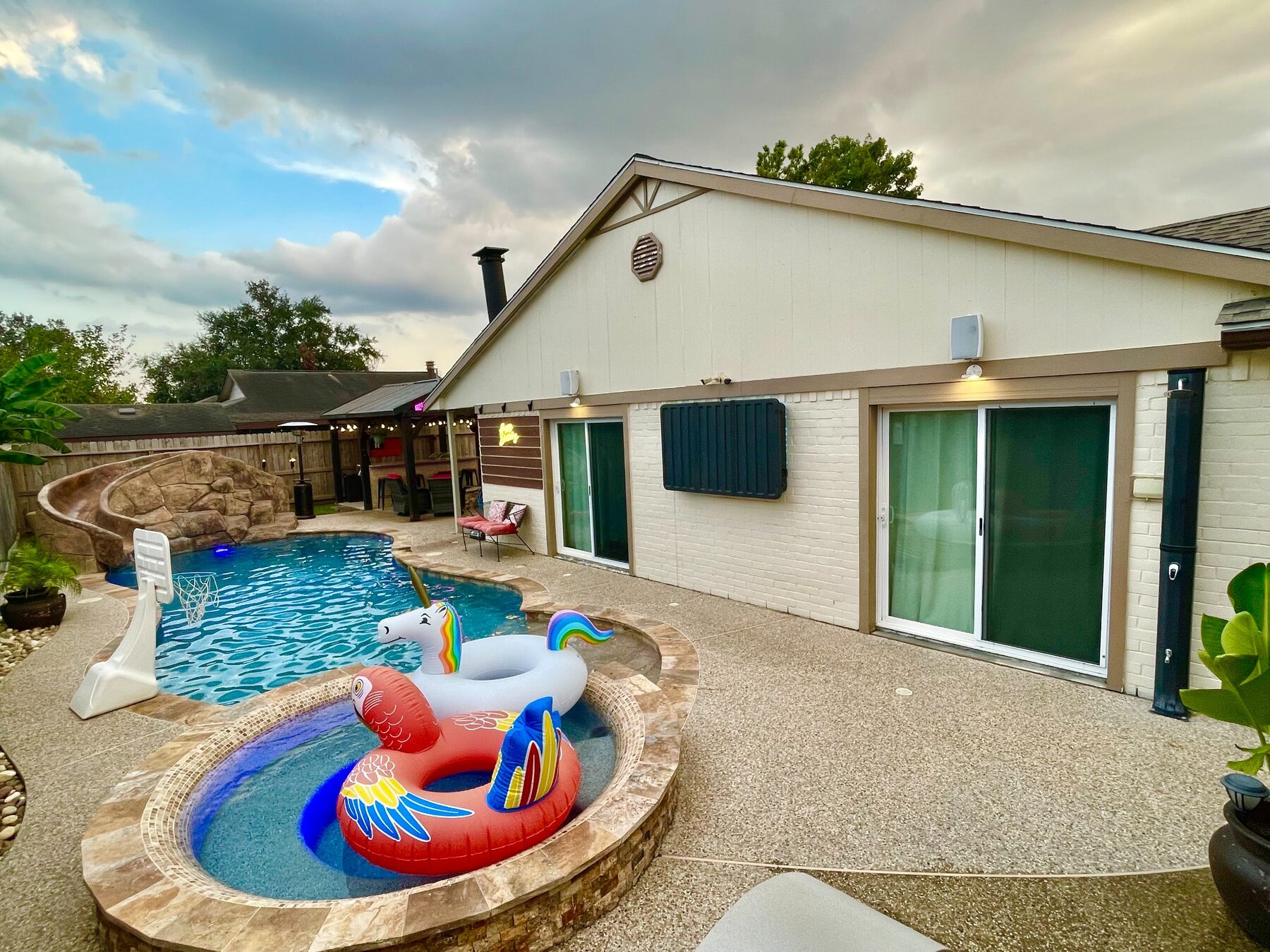 Wide daytime view of the pool and patio
