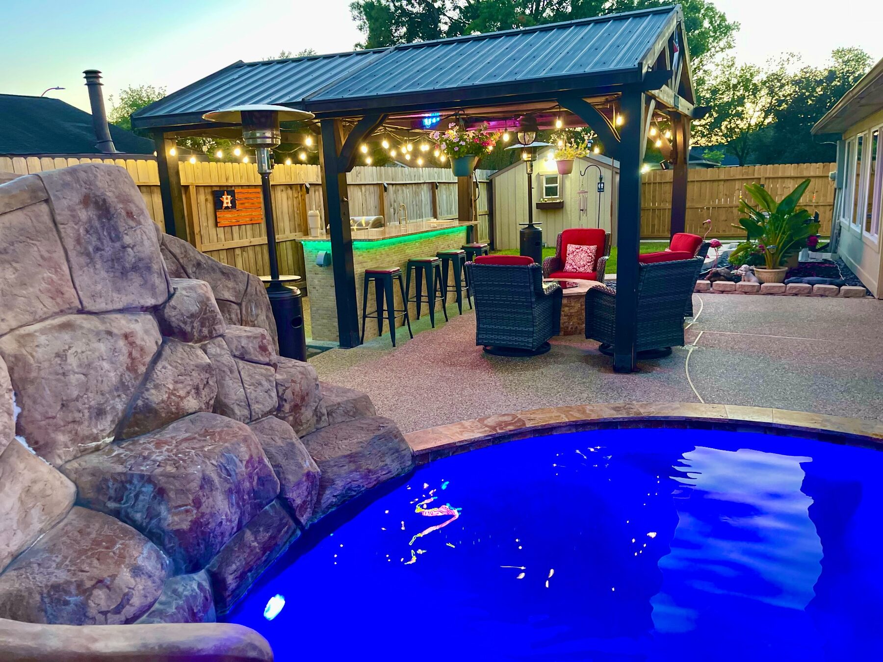 Rock waterslide beside a shaded gazebo and seating