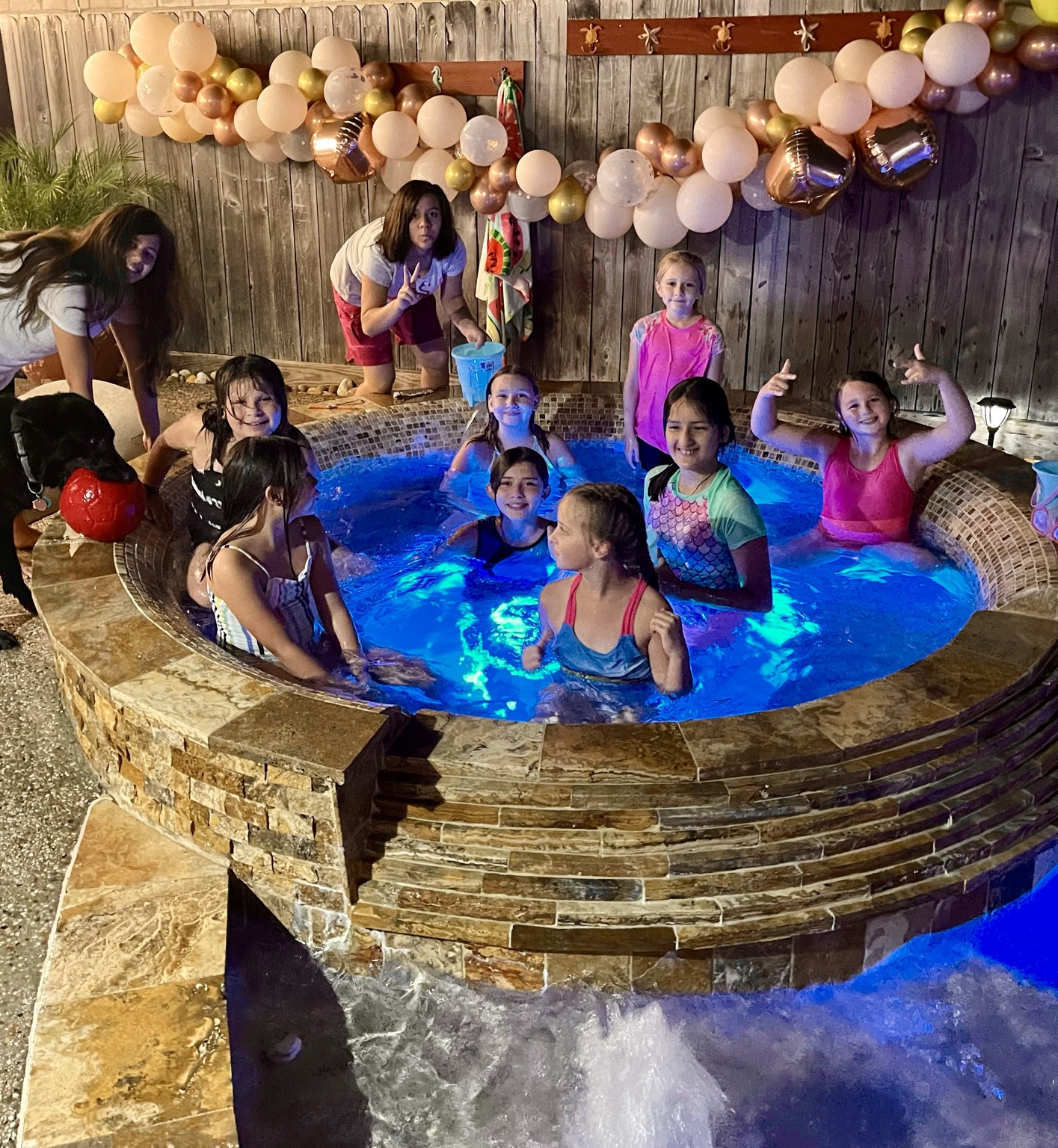 Children celebrating together in the spa area with birthday balloons